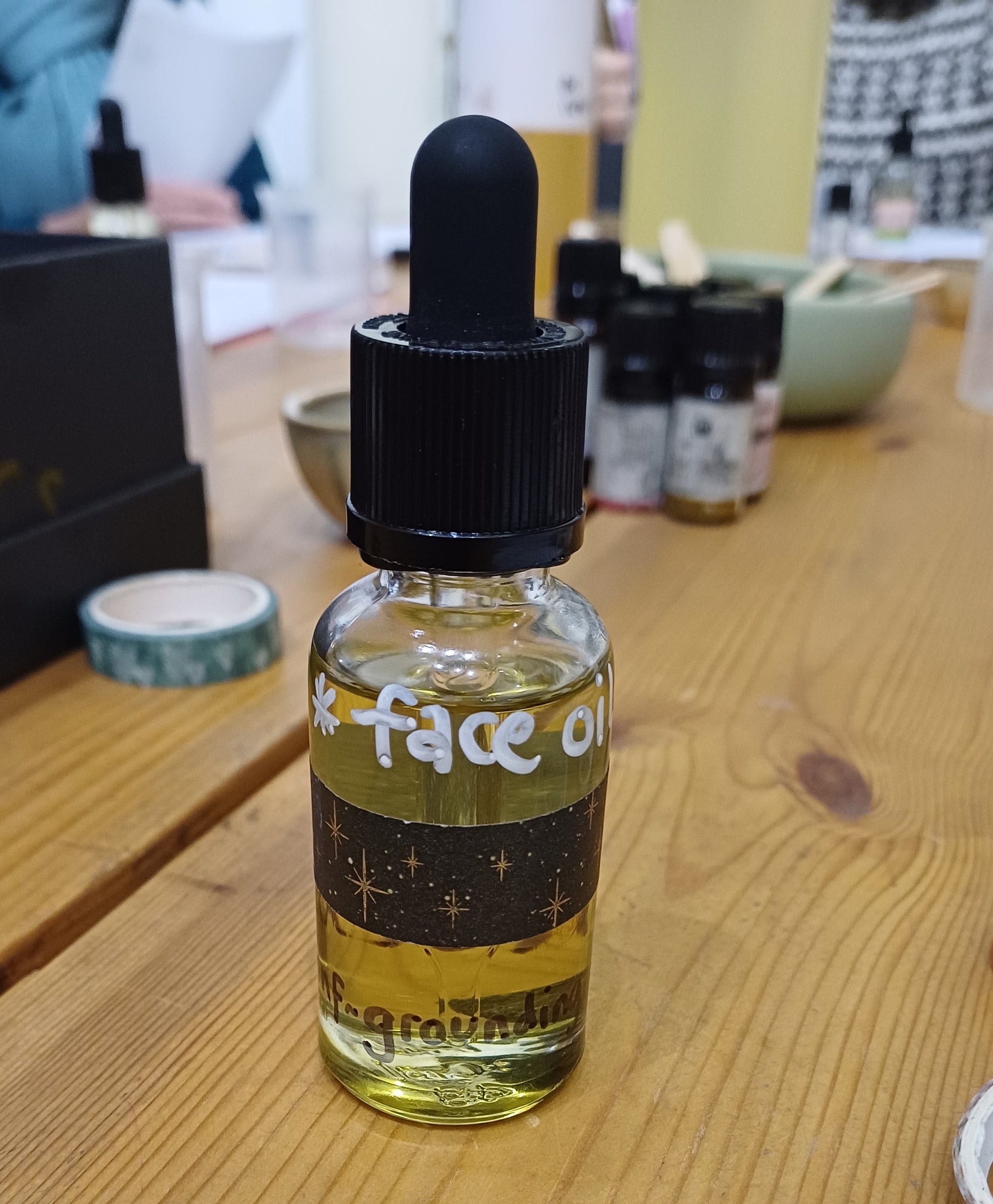 Bottle with dropper on a wooden surface
