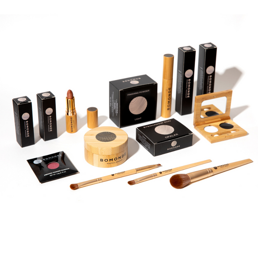 flat lay of Bomonde refillable make up products lined up. Sustainably packaged, lipsticks, powders, mascaras, eyeshadows and brushes