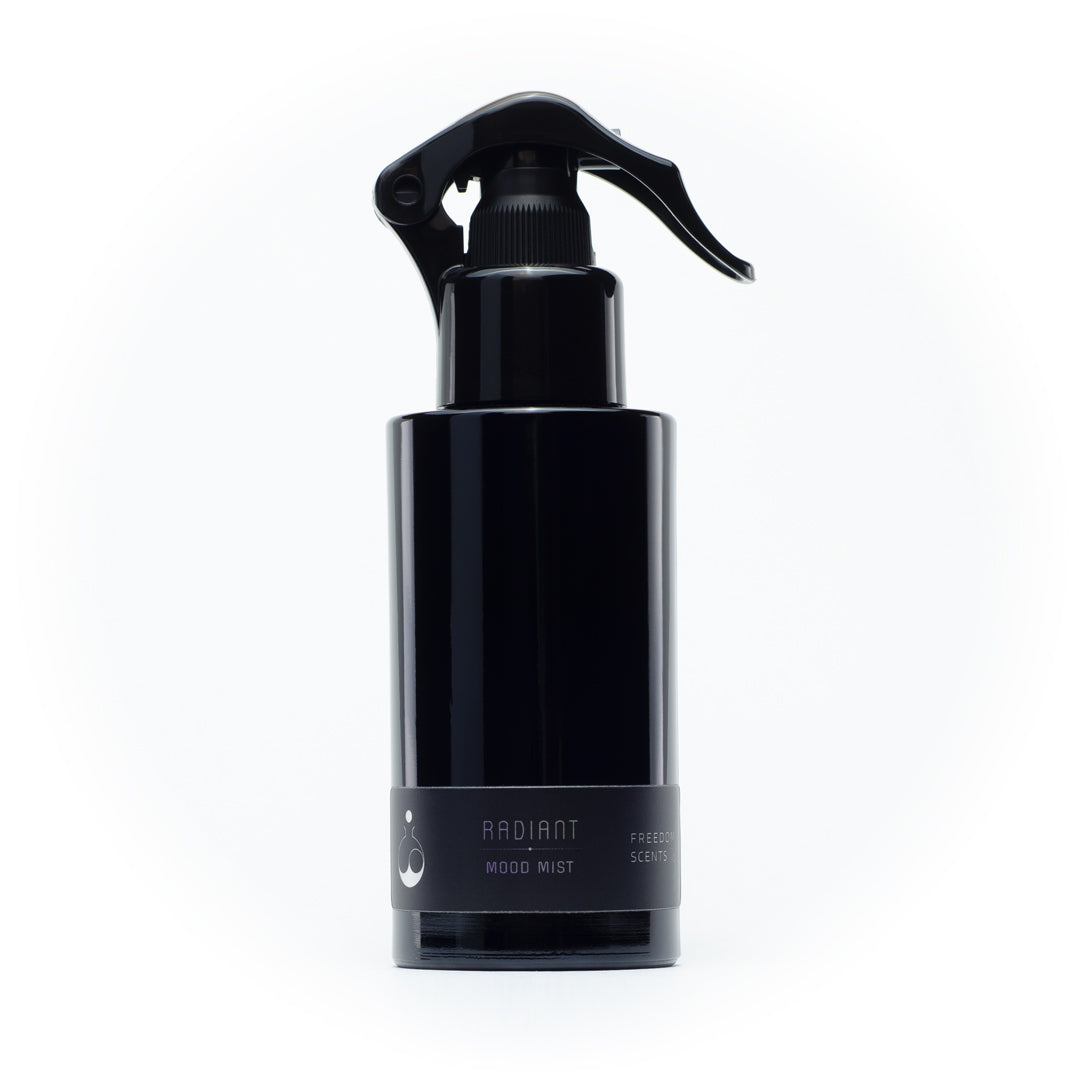 freedom scents home fragrance large black bottle with spray radiant scent on a white background