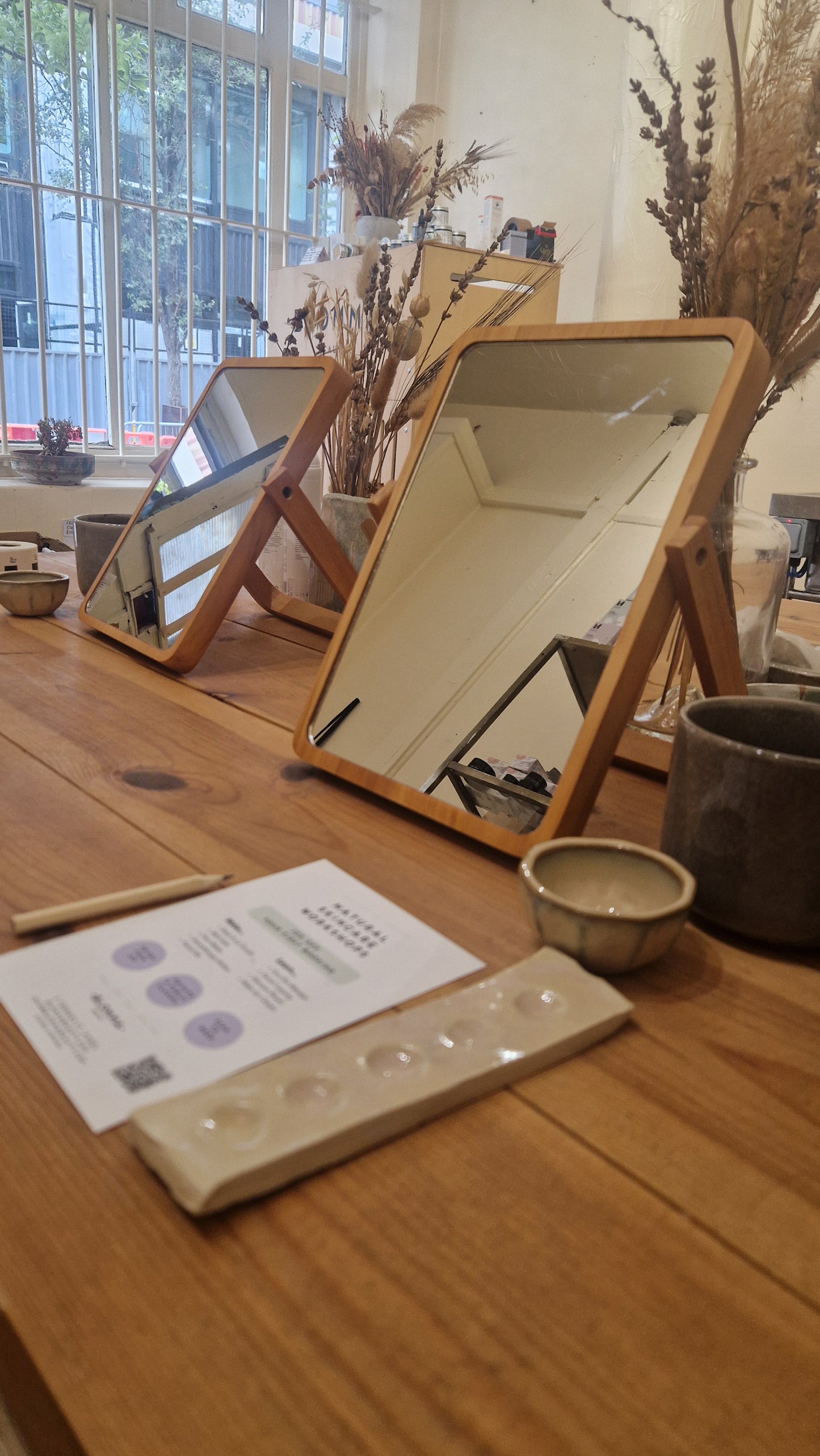 wooden table with mirror and palette set up for make up class