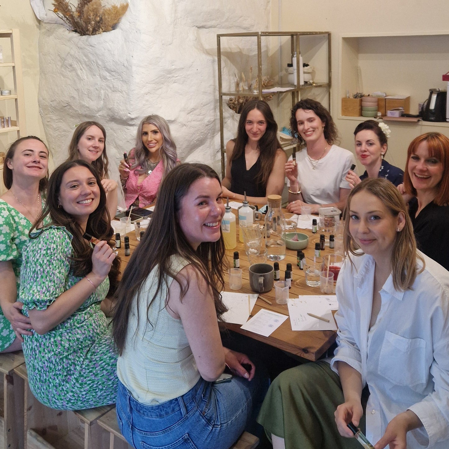 hen party group sitting around a table at a natural aromatherapy fragrance bledning workshop in london