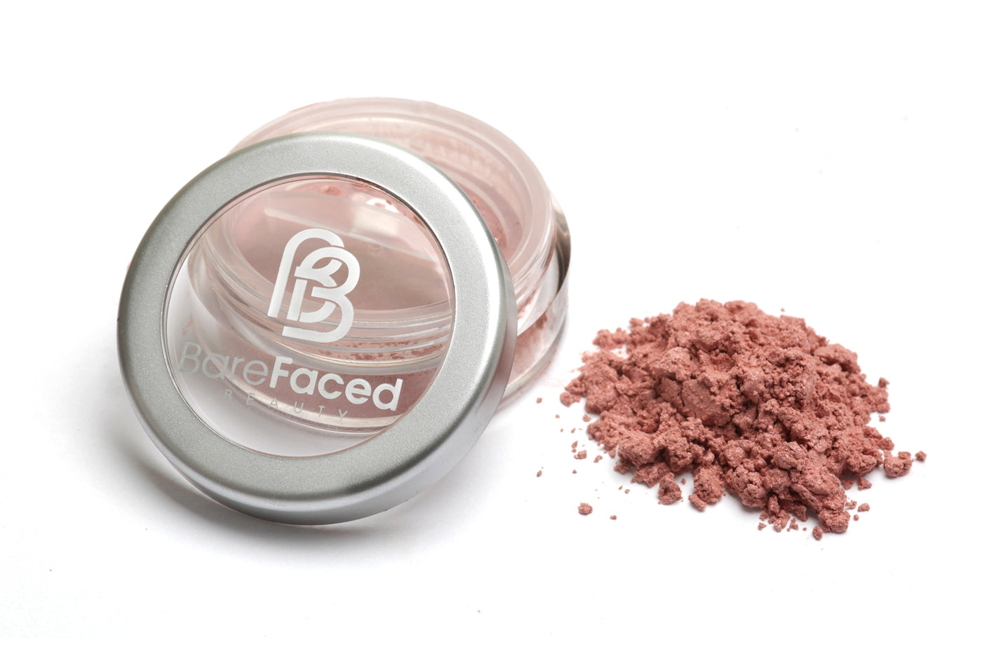 A small round pot of mineral blusher, with a swatch of the powder next to it showing a subtle satin, light peachy pink shade