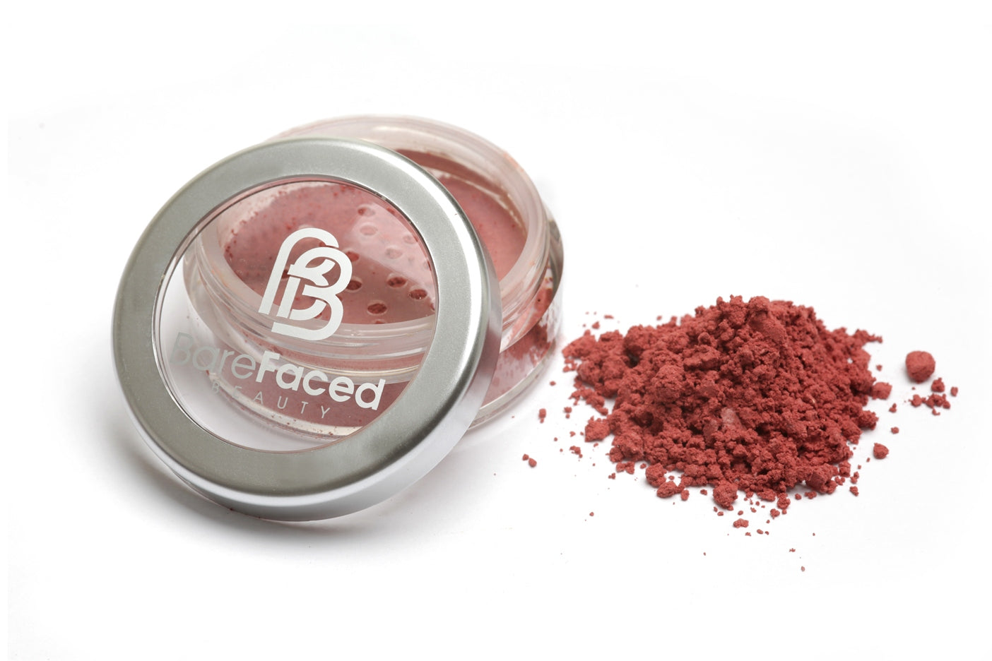 A small round pot of mineral blusher, with a swatch of the powder next to it showing a matt, rich rosey shade