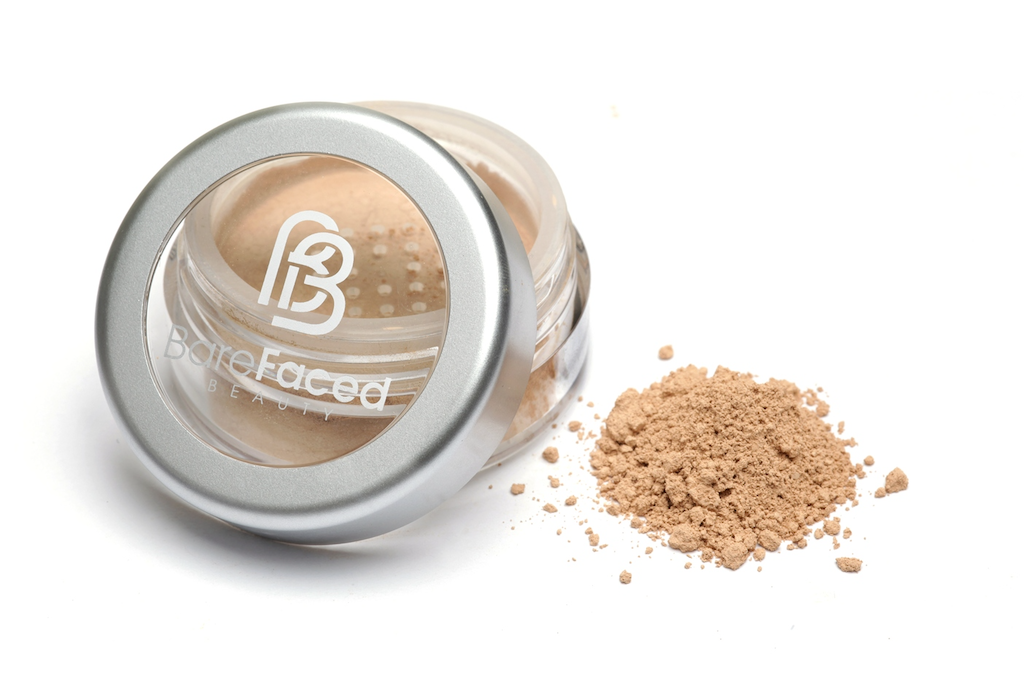 BareFaced Beauty Natural Mineral Foundation in Angelic. Ethical mineral makeup. The powder mineral foundation is pictured in a clear plastic jar with a small pile of the powder sitting next to it.
