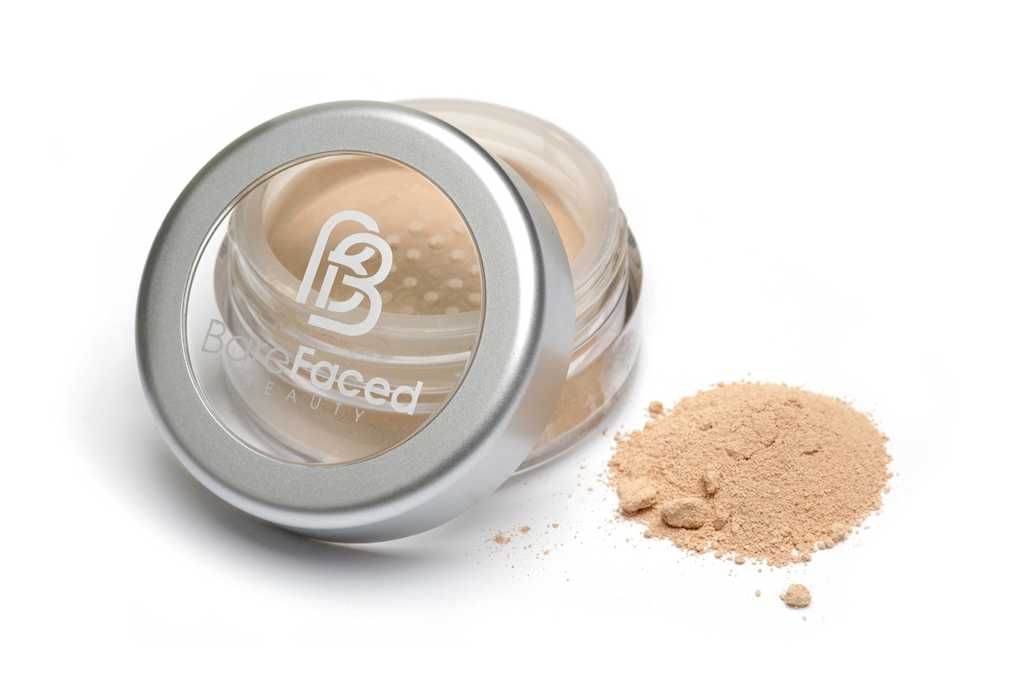 BareFaced Beauty Natural Mineral Foundation in Honest. Ethical mineral makeup. The powder mineral foundation is pictured in a clear plastic jar with a small pile of the powder sitting next to it.