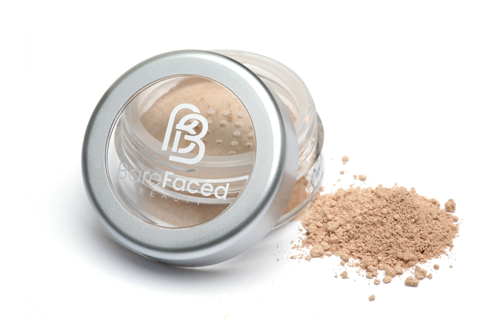 BareFaced Beauty Natural Mineral Foundation in Kissed. Ethical mineral makeup. The powder mineral foundation is pictured in a clear plastic jar with a small pile of the powder sitting next to it.