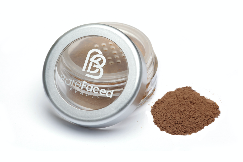 BareFaced Beauty Natural Mineral Foundation in Passion. Ethical mineral makeup. The powder mineral foundation is pictured in a clear plastic jar with a small pile of the powder sitting next to it.