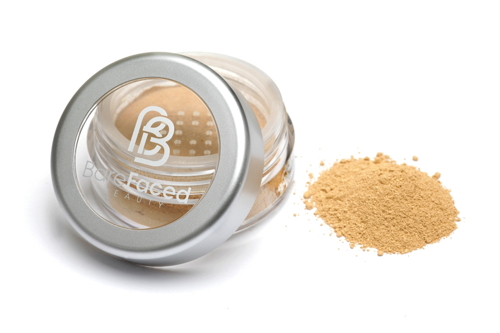 BareFaced Beauty Natural Mineral Foundation in True. Ethical mineral makeup. The powder mineral foundation is pictured in a clear plastic jar with a small pile of the powder sitting next to it.