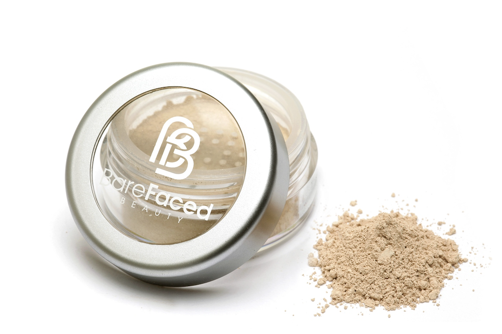 BareFaced Beauty Natural Mineral Foundation in Whisper. Ethical mineral makeup. The powder mineral foundation is pictured in a clear plastic jar with a small pile of the powder sitting next to it.