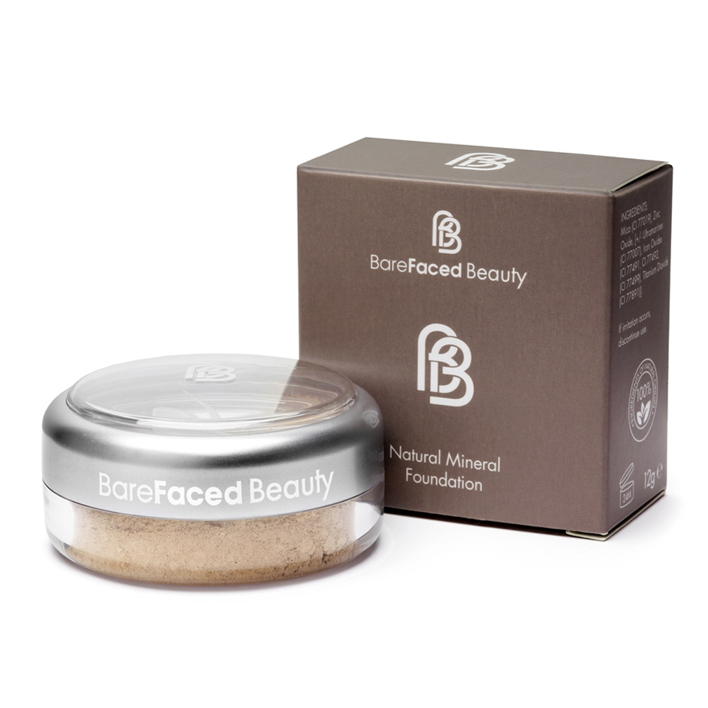 BareFaced Beauty Natural Mineral Foundation. Natural Makeup. The powder mineral foundation is pictured in a clear plastic jar with a silver lid, in front of the brown box with the BareFaced logo in white.
