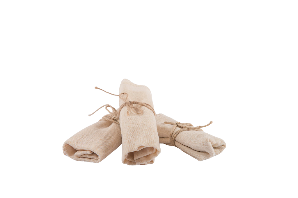Casa Mencarelli Organic Cotton Face Cloths. Certified organic cotton cloths. The three cotton cloths are pictured rolled up with twine and stacked in a fan shape.
