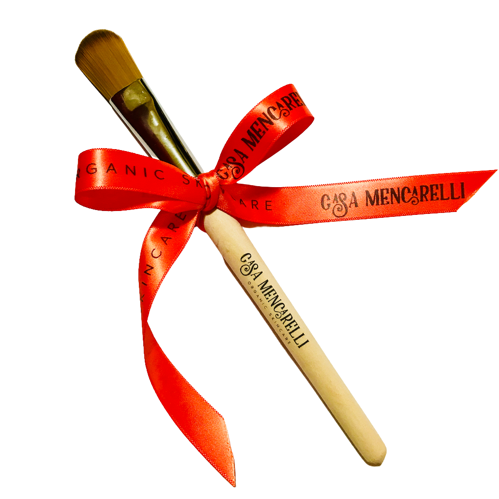 Casa Mencarelli Face Mask Brush. Sustainably sourced face mask brush. The wooden mask brush is branded on the stem with the Casa Mencarelli logo, and wrapped in a bow with red branded ribbon.