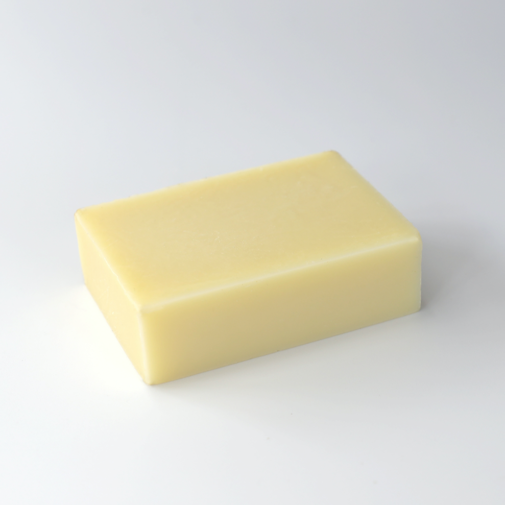 plain creamy coloured rectangle of soap on a white background