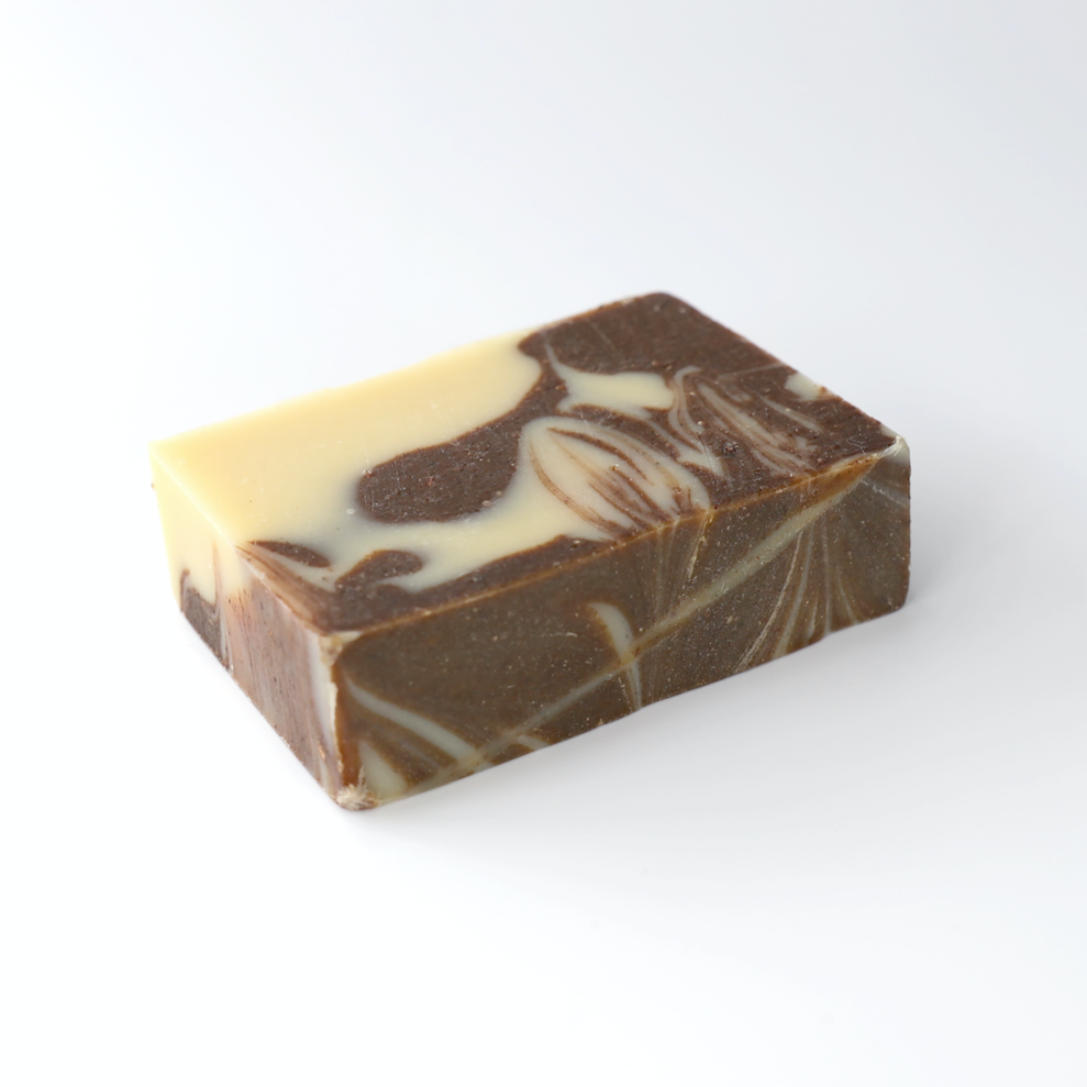 bar of creamy and chocolatey coloured swirled soap on a white background