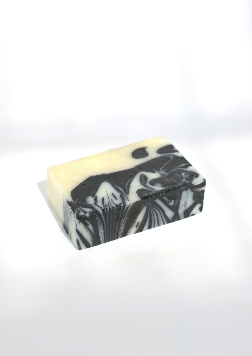 The white and blue marbled soap bar is pictured alone on a plain white background.