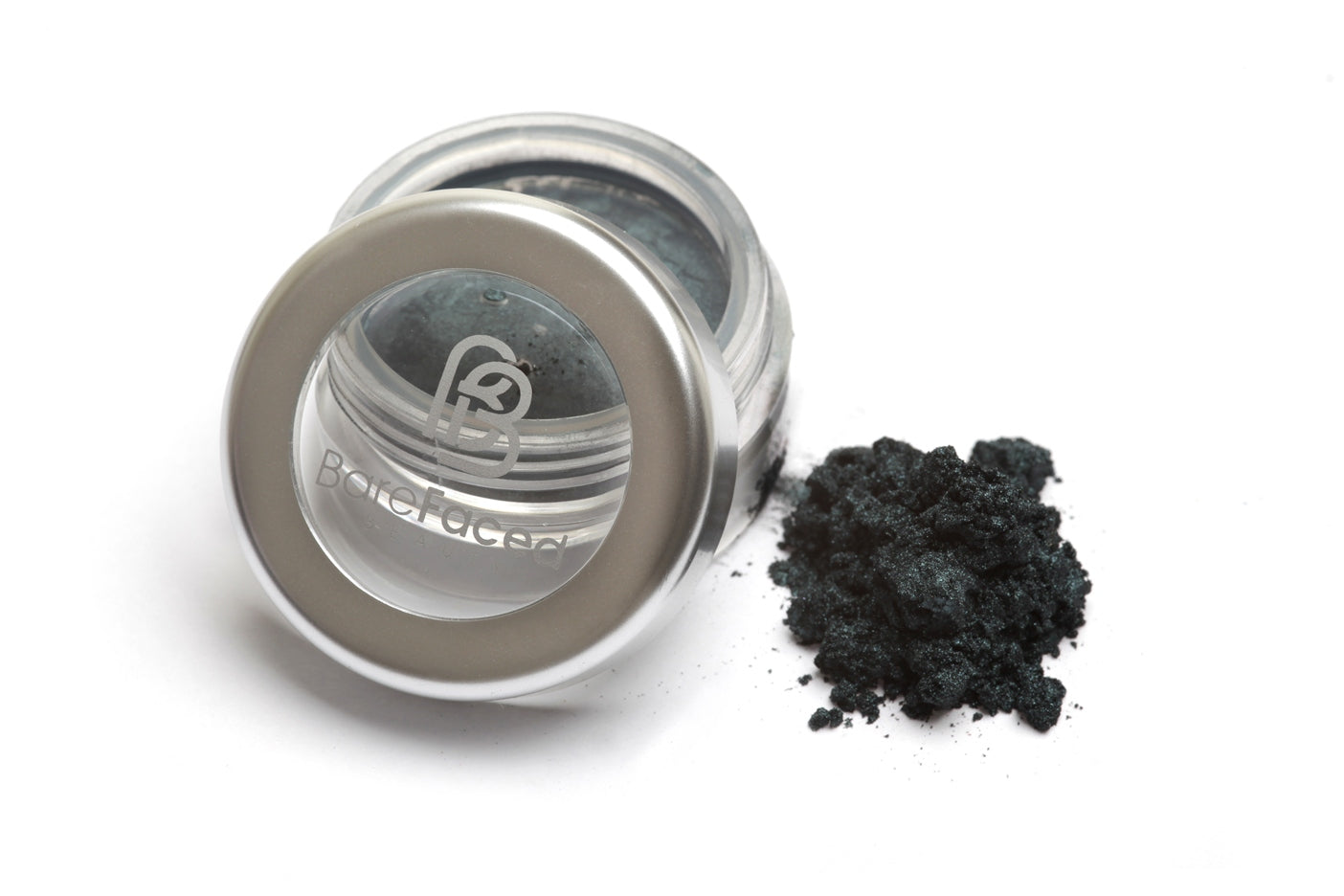 A small round pot of mineral eyeshadow, with a swatch of the powder next to it showing a shimmery black shade with a hint of blue and green