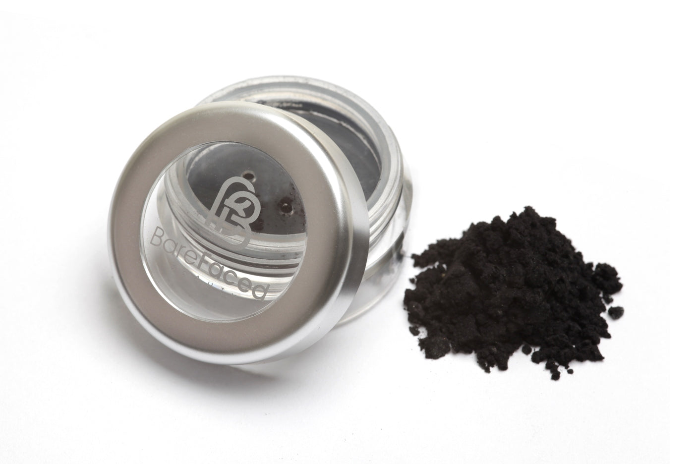 A small round pot of mineral eyeshadow, with a swatch of the powder next to it showing a smokey black matt shade