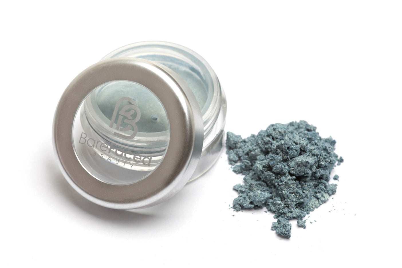 A small round pot of mineral eyeshadow, with a swatch of the powder next to it showing a light shimmery aqua shade