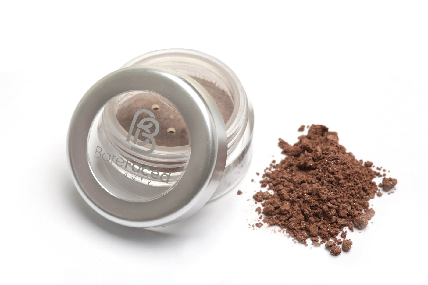 A small round pot of mineral eyeshadow, with a swatch of the powder next to it showing a semi-matt medium brown shade