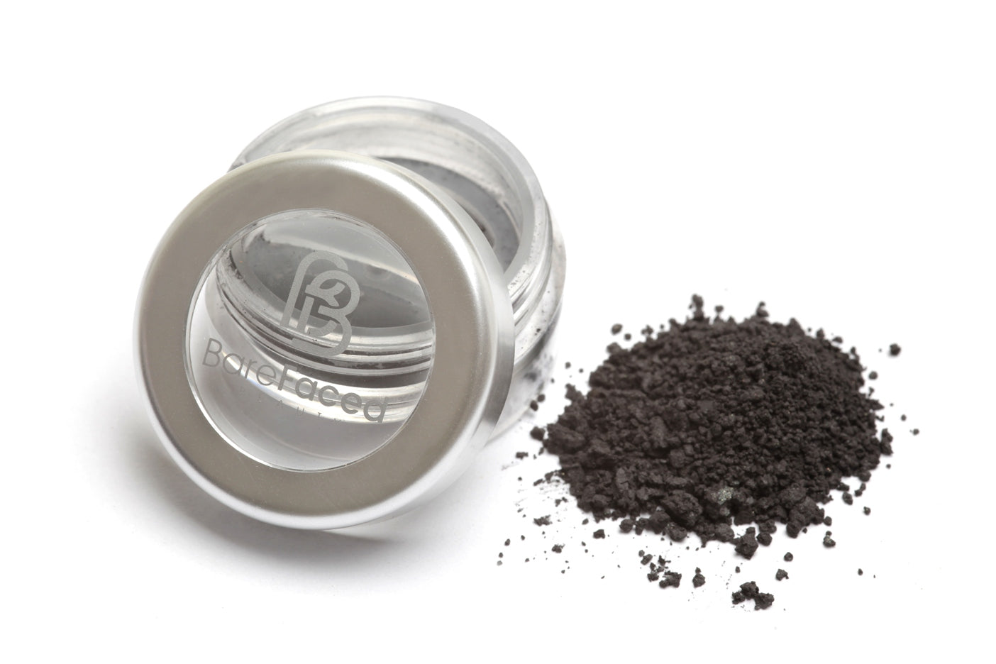 A small round pot of mineral eyeshadow, with a swatch of the powder next to it showing a smokey matt grey