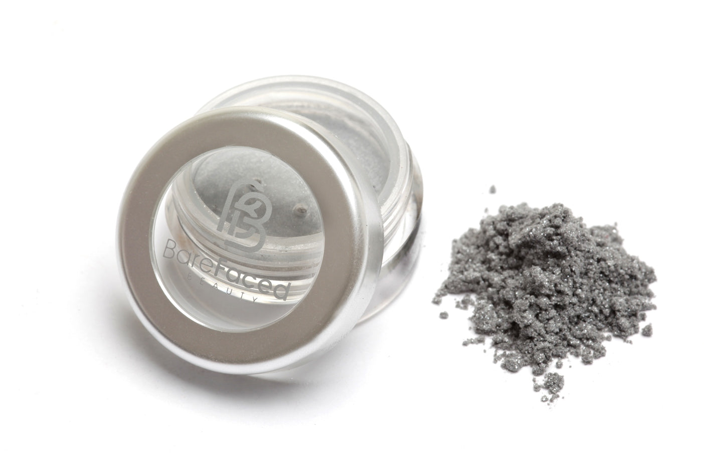 A small round pot of mineral eyeshadow, with a swatch of the powder next to it showing a sparkling silver grey shade