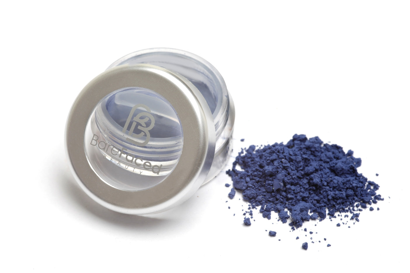 A small round pot of mineral eyeshadow, with a swatch of the powder next to it showing a matt deep smokey blue shade
