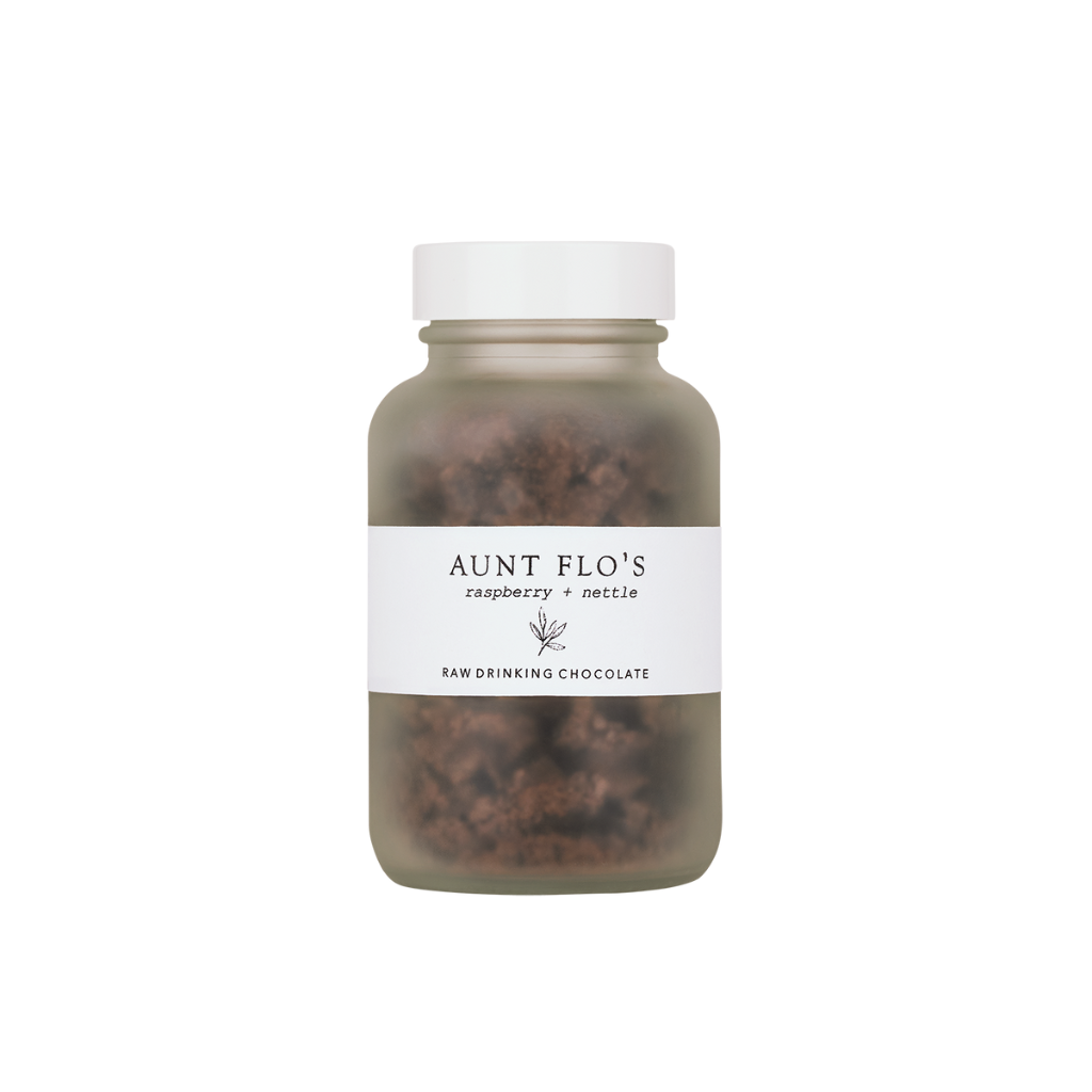 Forage Botanicals Aunt Flo's Raw Drinking Chocolate. Natural iron supplement. The raw cacao is pictured in a smokey glass jar with a simple white label.