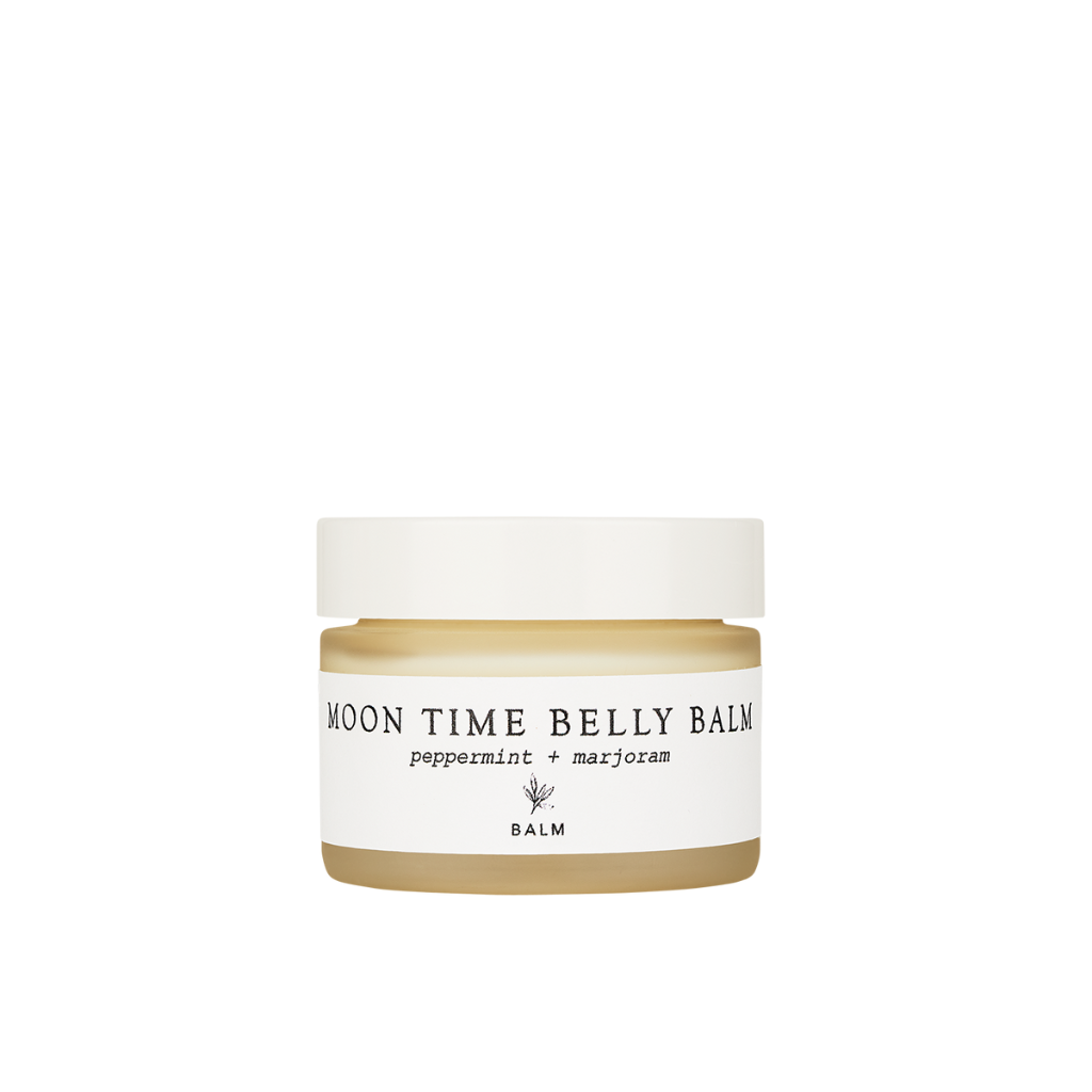 Forage Botanicals Moon Time Belly Balm. Natural menstrual cramp relief. The balm is pictured in a frosted glass jar with a white lid and label.