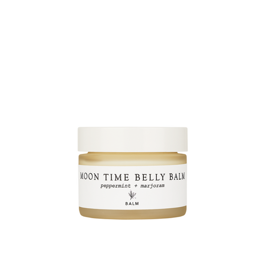 Forage Botanicals Moon Time Belly Balm. Natural menstrual cramp relief. The balm is pictured in a frosted glass jar with a white lid and label.