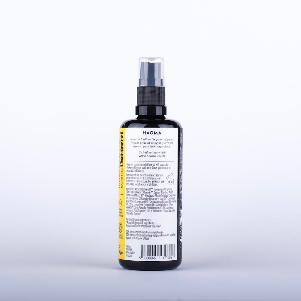 Haoma Organic Foot and Shoe Spray. Certified vegan foot smell remedy. The spray is pictured in a black glass bottle with a black plastic spray pump. The back of the label is shown with the ingredients text.