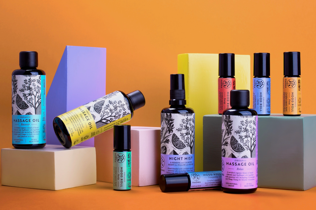 Haoma Organic Massage Oils. Natural and organic aromatherapy products. The oils are pictured with other Haoma aromatherapy products on colourful plinths.