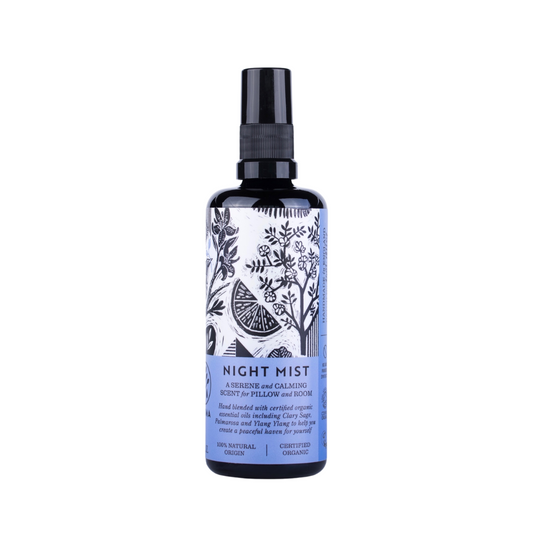 A dark glass spray bottle. The "Night Mist" spray from Haoma is decorated with botanical illustrations. The text describes it as a serene and calming scent and pillow mist made with certified organic essential oils. It is 100% natural, organic, and certified.