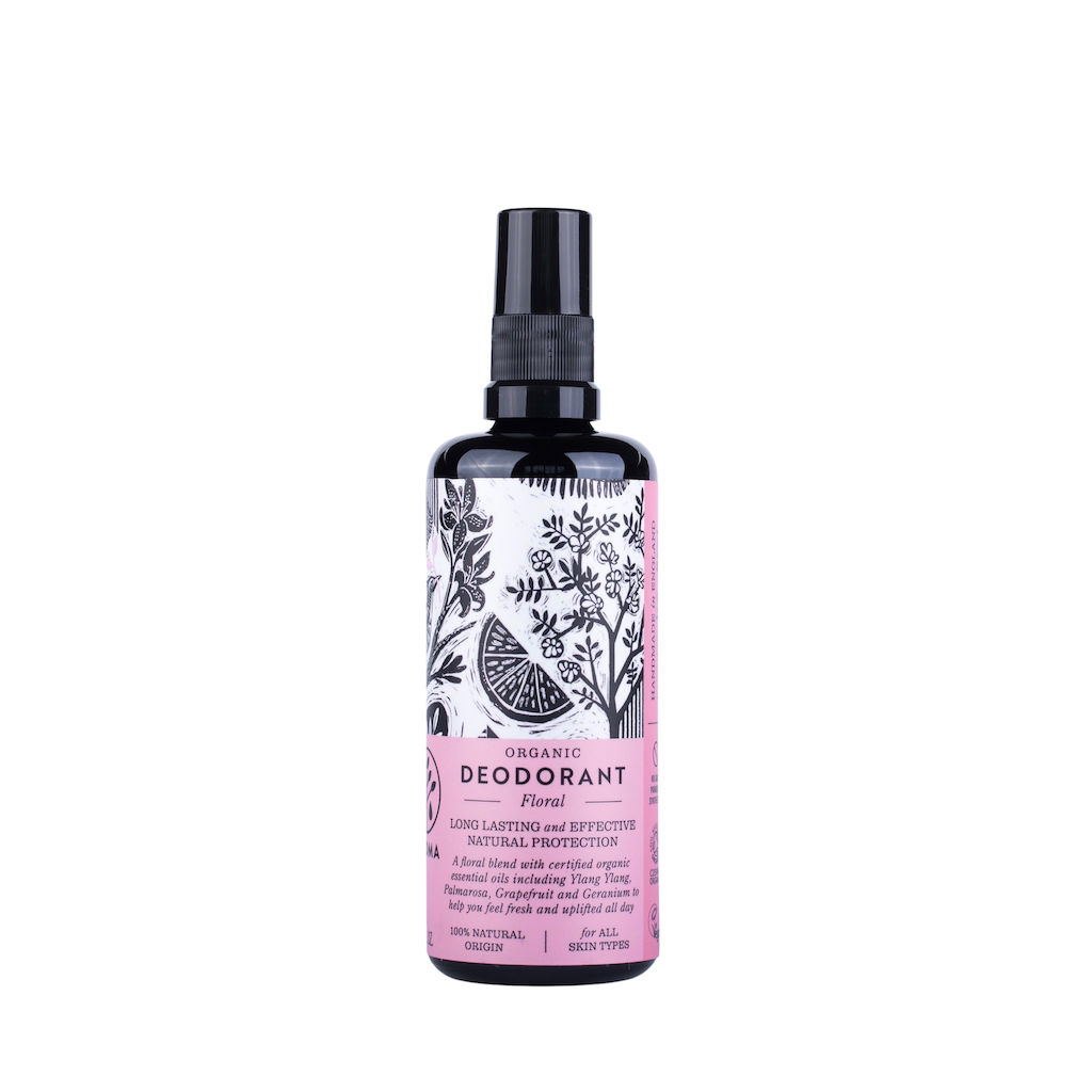 Haoma Organic Deodorant in Floral. Certified organic deodorant. The spray deodorant is packaged in a black glass bottle with a pink label and black illustrations of plants.