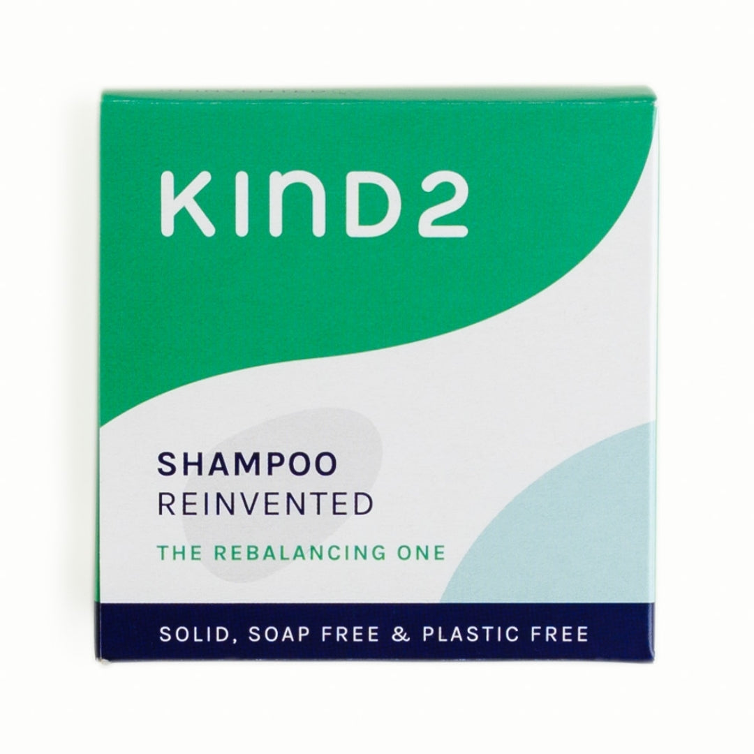 An image of the white/green cardboard box of the KIND2 rebalancing shampoo bar