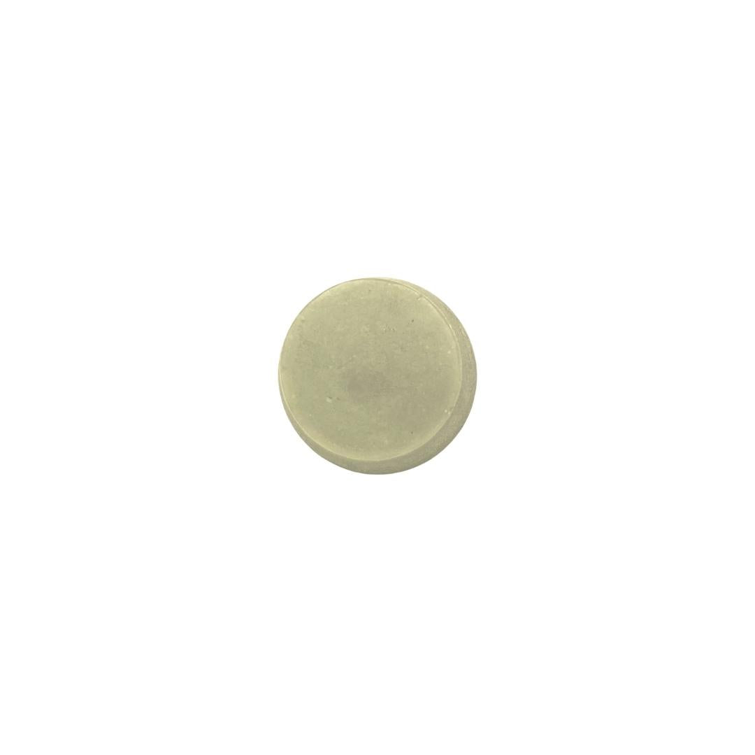 Small round off white soap on a white background