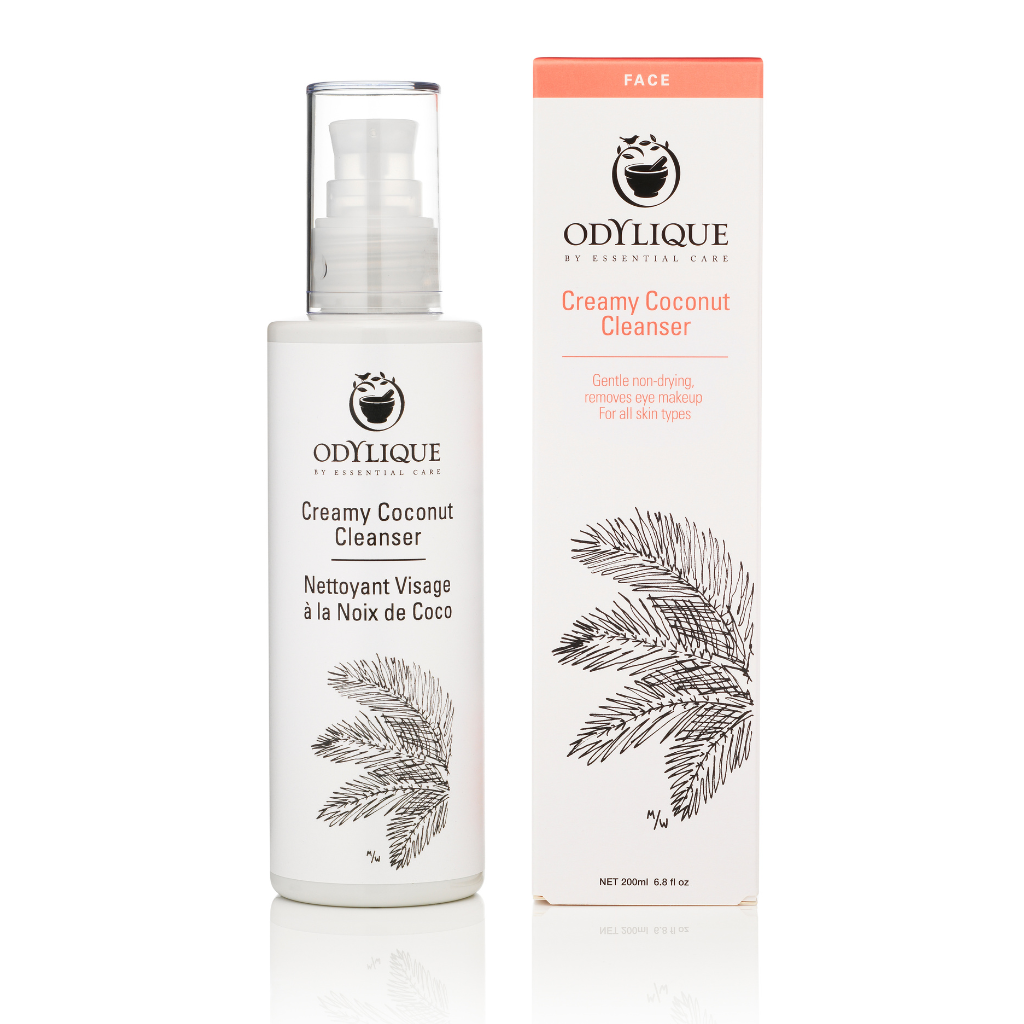 Odylique Creamy Coconut Cleanser. Cruelty free skincare. The 200ml white plastic bottle with a pump is shown next to the paper box it comes in. It is illustrated with a leaf in black and pink text.