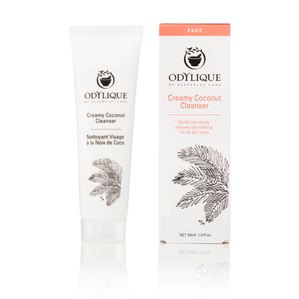 Odylique Creamy Coconut Cleanser. Certified organic skincare. The 30ml white plastic tube is shown next to the paper box it comes in. It is illustrated with a leaf in black and pink text.