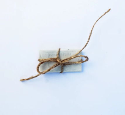 safety razor replacement blades individually wrapped in grease paper and tied with a brown twine string