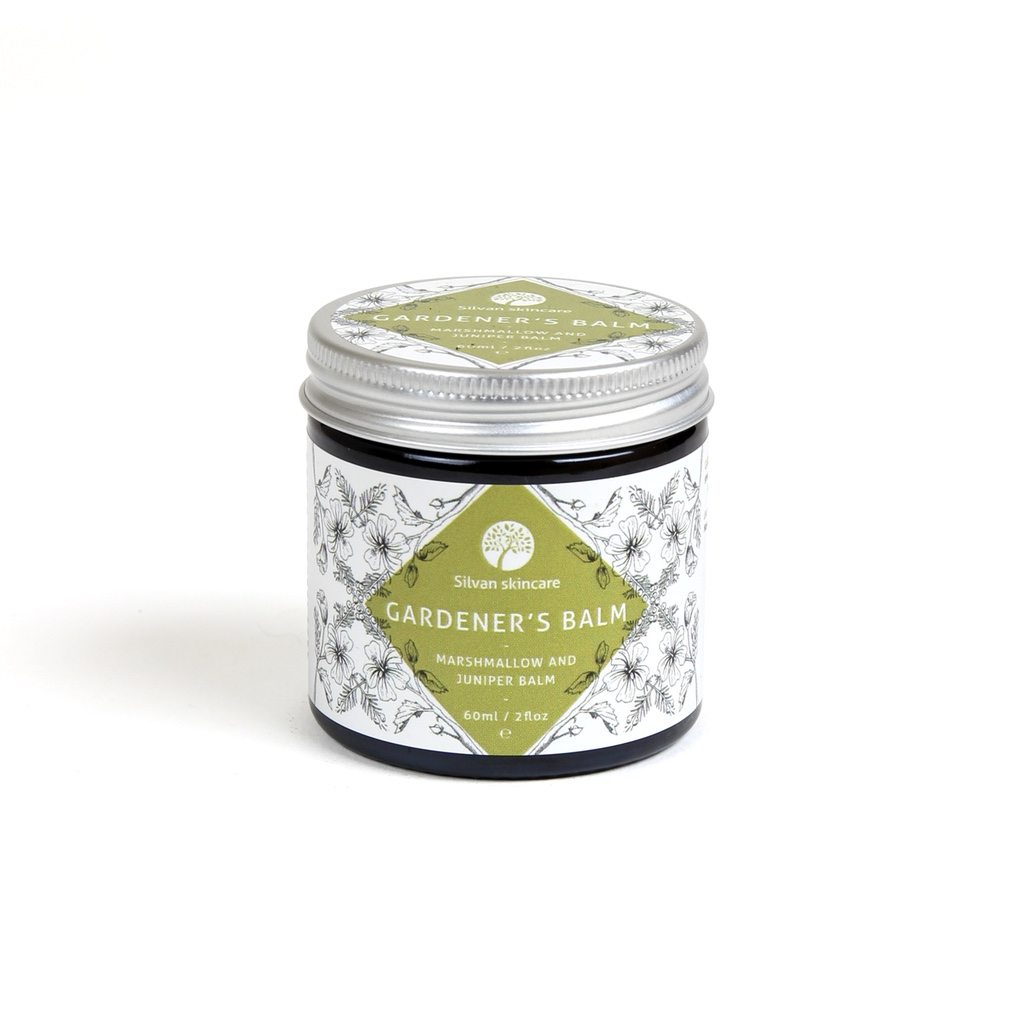 Silvan Skincare Gardener's Balm. Vegan dry skin remedy. Pictured in an amber glass jar with an aluminium lid with a delicately illustrated white and olive green label.