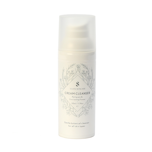 Silvan Skincare Cream Cleanser. Gentle natural face cleanser. Packaged in a white plastic bottle with a pump, with delicate floral illustrations in blue.