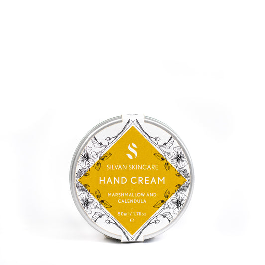 silvan skincare hand cream on a white background. the hand cream is in an aluminium pot with a white and yellow labels which reads: silvan skincare hand cream marshmallow and calendula 50ml