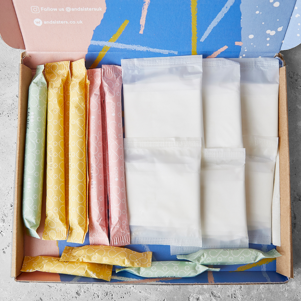 &Sisters My First Period Pack. Sustainable period products for teenagers. The box is open showing tampons and pads all made of organic cotton.