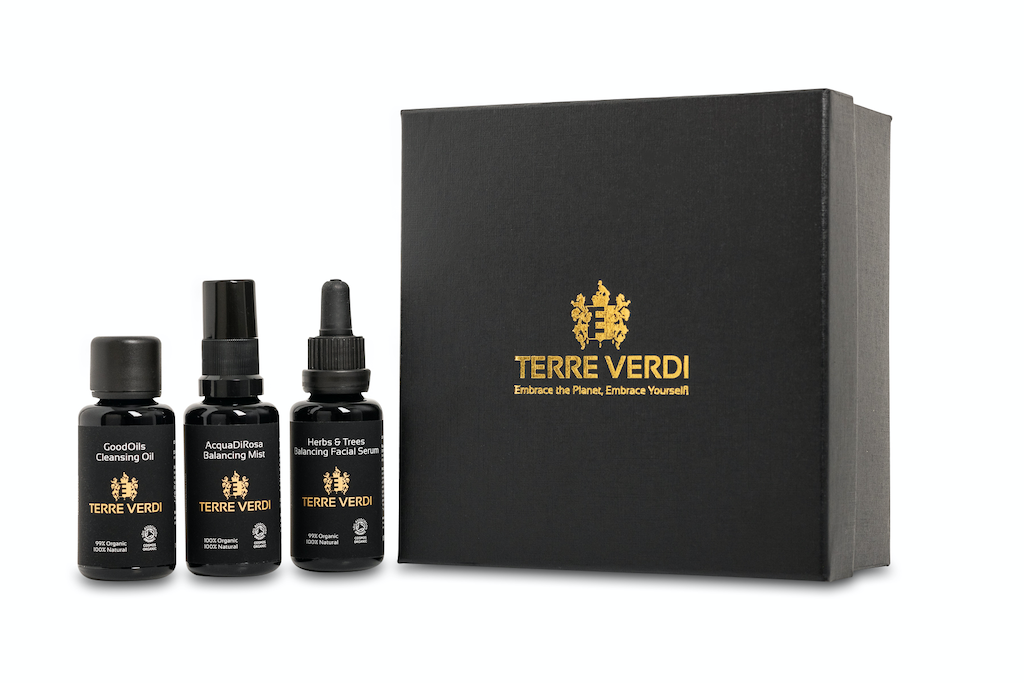 Terre Verdi Organic Gift Set for Face with Balancing Face Serum. Natural skincare gift set. All of the products are in black bottles and stand next to a luxury black box embossed in gold with the Terre Verdi logo.