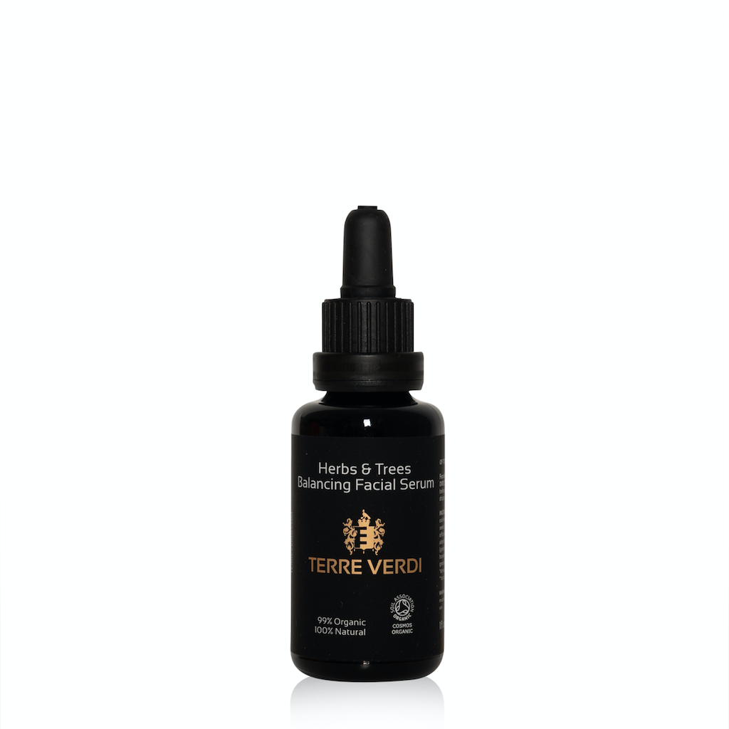 Terre Verdi Herbs & Trees Balancing Facial Serum. Certified cruelty free face oil. In a black glass bottle with a black plastic pipette. The label is black with the logo in gold in the centre and all other text in white.