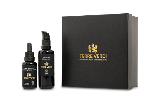 Terre Verdi Nourishing Gift Set. Certified organic skincare gift set. Both products are in black bottles and stand next to a luxury black box embossed in gold with the Terre Verdi logo.