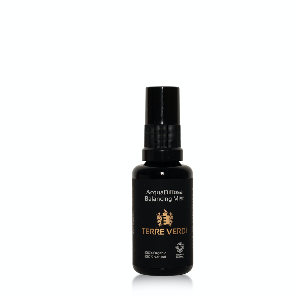 Terre Verdi AcquadiRosa Balancing Mist Travel Size. Certified Organic Skincare. The product is in a black glass bottle with a black plastic spray nozzle. It is labeled in black with the logo in gold and other text in white.
