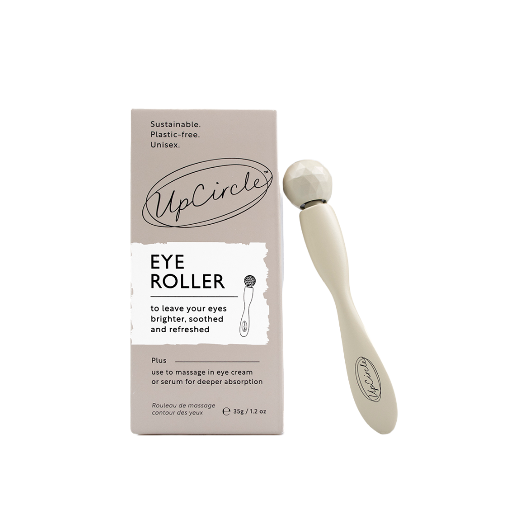 Upcircle eye roller tool on a white background. On the left you can see the box for the eye roller tool which reads 'sustainable, plastic free, unisex