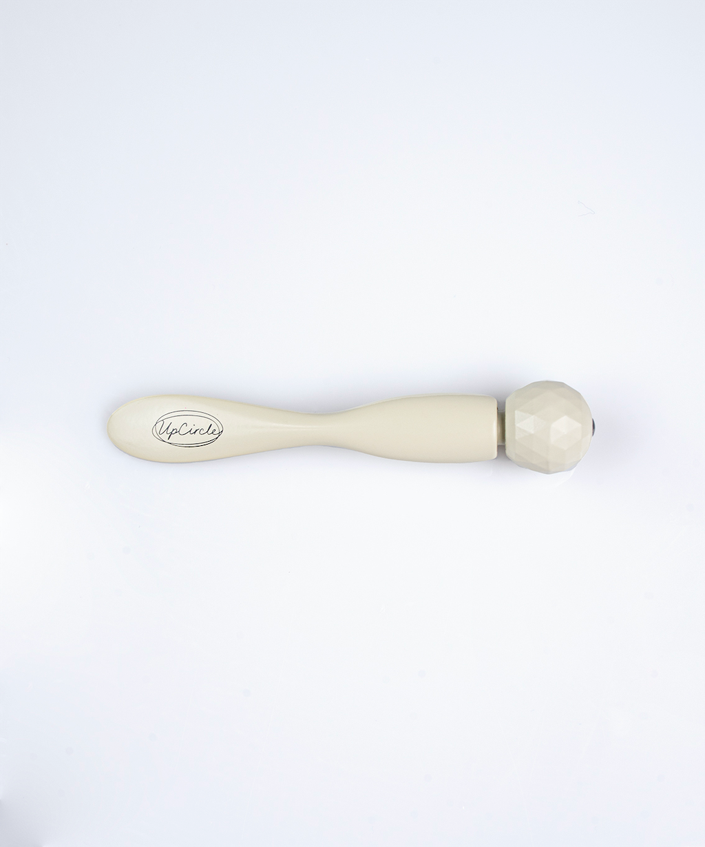 upcircle beauty eye roller tool laid flat on a white background