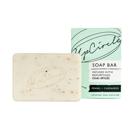 UpCircle Fennel and Cardamom Soap Bar. Natural soap bar. The pale coloured soap bar is sitting next to its green branded box.