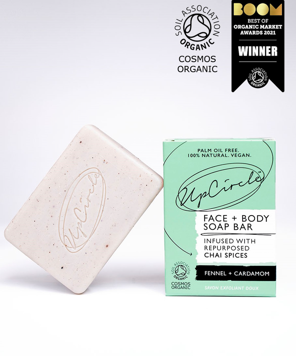 UpCircle Fennel and Cardamom Soap Bar. Natural soap bar. The pale coloured soap bar is sitting next to its green branded box. A Boom award is photo collaged on the image.